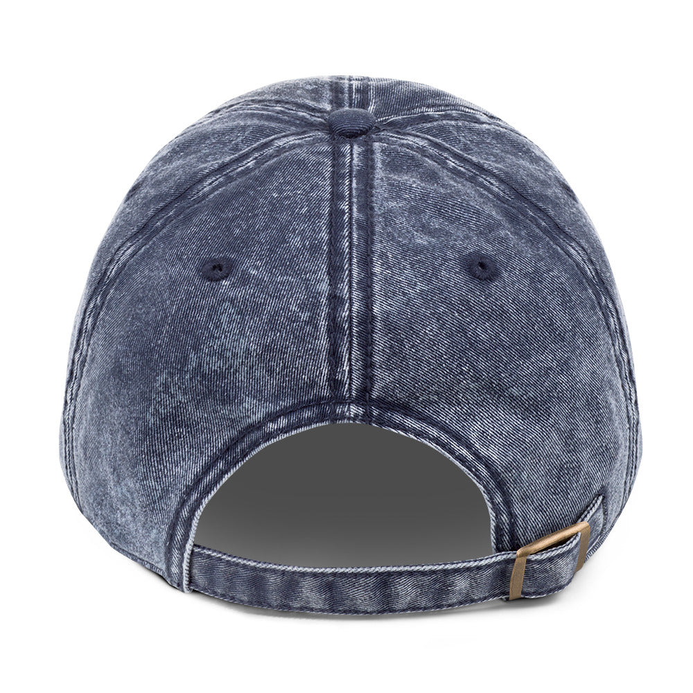 The Mark Heritage Cap in navy cotton twill with antique-brass buckle, back view