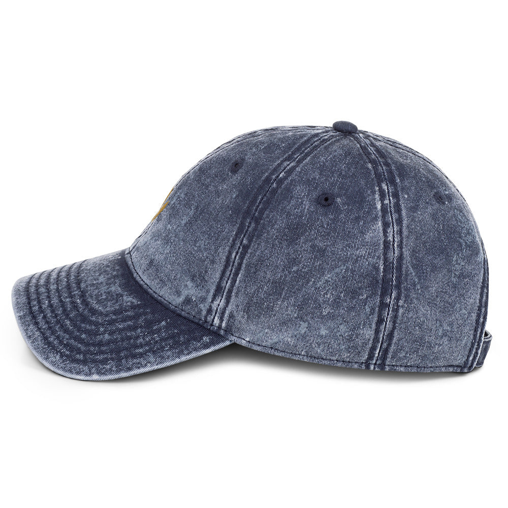 The Mark Heritage Cap in navy cotton twill with embroidered Old Gold Harvest mark, left-side view